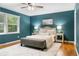 Main bedroom with hardwood floors, large area rug, and decorative lamps at 1920 Jett Ridge Rd, Cumming, GA 30041
