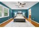 Main bedroom with hardwood floors, large area rug, and decorative lamps at 1920 Jett Ridge Rd, Cumming, GA 30041