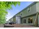 Back of home featuring multiple units, outdoor patios, sliding doors and green siding at 3379 Thornbridge Dr, Powder Springs, GA 30127