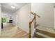 Inviting entryway with staircase and wood-look floors leading to a living area with fireplace and patio doors at 3379 Thornbridge Dr, Powder Springs, GA 30127