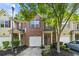 Charming townhouse with brick facade, attached garage, and well-maintained front yard landscaping at 3379 Thornbridge Dr, Powder Springs, GA 30127