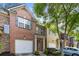 Beautiful townhouse featuring brick facade, attached garage, and manicured landscaping at 3379 Thornbridge Dr, Powder Springs, GA 30127