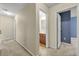 Hallway featuring neutral walls and carpet, leading to a bathroom and bedrooms at 3379 Thornbridge Dr, Powder Springs, GA 30127