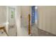 Well-lit hallway with neutral walls and carpet, leading to various rooms in the home at 3379 Thornbridge Dr, Powder Springs, GA 30127
