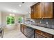 Traditional kitchen with wood cabinets, tile backsplash, stainless appliances, and adjacent dining area at 3379 Thornbridge Dr, Powder Springs, GA 30127