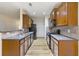 Traditional kitchen featuring wood cabinets, black appliances, and a stylish tile backsplash at 3379 Thornbridge Dr, Powder Springs, GA 30127