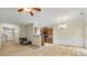Spacious living area featuring wood-look floors, a fireplace, dining area, and kitchen with bar seating at 3379 Thornbridge Dr, Powder Springs, GA 30127