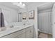 Bright bathroom with white cabinets, double sinks, and framed art of giraffes in bathtubs at 4779 Bogan Meadows Dr, Buford, GA 30519