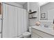 Cozy bathroom featuring a tub with a shower, toilet, and floating shelves that adds a modern touch to the home at 4779 Bogan Meadows Dr, Buford, GA 30519