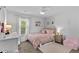 Cozy bedroom with carpet, ceiling fan, a -size chair, and soft pink decor at 4779 Bogan Meadows Dr, Buford, GA 30519