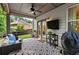 View of the outdoor covered patio area complete with furniture, ceiling fan, and a view of the backyard at 4779 Bogan Meadows Dr, Buford, GA 30519