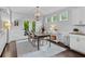 Dining room featuring natural light, hardwood floors, modern light fixture, and direct access to the backyard through glass doors at 4779 Bogan Meadows Dr, Buford, GA 30519