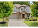 Charming two-story home with stone accents, attached garage, and a well-manicured front yard at 4779 Bogan Meadows Dr, Buford, GA 30519