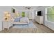 The main bedroom is sun-filled with a ceiling fan, neutral walls, and two dressers for plenty of storage space at 4779 Bogan Meadows Dr, Buford, GA 30519