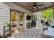 Covered outdoor patio area with ceiling fan and comfortable seating at 4779 Bogan Meadows Dr, Buford, GA 30519