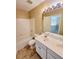 This is a bathroom with double sinks, white cabinets, and a bathtub with white subway tiles at 6005 Pattingham Dr, Roswell, GA 30075