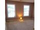 A bedroom with carpeted floors and two windows with blinds and a lamp on the floor at 6005 Pattingham Dr, Roswell, GA 30075