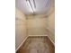A walk-in closet with carpeted floor and multiple shelves for clothing storage at 6005 Pattingham Dr, Roswell, GA 30075