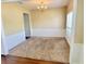 Formal dining room with a modern chandelier and wainscotting at 6005 Pattingham Dr, Roswell, GA 30075