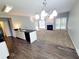 Open kitchen with breakfast bar and views of the fireplace in the living room at 6005 Pattingham Dr, Roswell, GA 30075