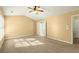 Bright main bedroom with a ceiling fan and a door to the main bath at 6005 Pattingham Dr, Roswell, GA 30075