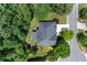 An aerial view of a home in a neighborhood setting, surrounded by mature trees and lush greenery at 1085 Highland Crest Ct, Mableton, GA 30126