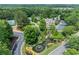 A beautiful landscaped pond with a fountain and manicured gardens, near a home and tennis court at 1085 Highland Crest Ct, Mableton, GA 30126