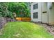 A view of the backyard with healthy grass and a retaining wall at 1085 Highland Crest Ct, Mableton, GA 30126