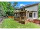 Exterior view of backyard with screened-in porch and lush landscaping at 1085 Highland Crest Ct, Mableton, GA 30126
