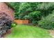 Well-manicured backyard featuring a lush lawn and mature trees at 1085 Highland Crest Ct, Mableton, GA 30126