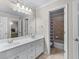 Bathroom with a dual sink vanity, neutral wall color, tile floor, and a shower/tub combo at 1085 Highland Crest Ct, Mableton, GA 30126