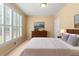 Cozy bedroom with large window, neutral decor, plush carpet, and artwork at 1085 Highland Crest Ct, Mableton, GA 30126