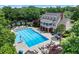 Large community pool surrounded by lounge chairs and a charming clubhouse, perfect for summer relaxation at 1085 Highland Crest Ct, Mableton, GA 30126