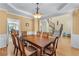 Formal dining room with hardwood floors, decorative chandelier, and staircase in background at 1085 Highland Crest Ct, Mableton, GA 30126