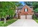Two-story brick home with a well-maintained lawn and mature trees at 1085 Highland Crest Ct, Mableton, GA 30126
