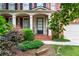 Inviting brick home with a covered front porch and manicured landscaping at 1085 Highland Crest Ct, Mableton, GA 30126