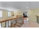 Open second floor landing with access to bedrooms and stairwell with wood and wrought iron railings at 1085 Highland Crest Ct, Mableton, GA 30126