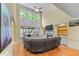 Bright living room featuring vaulted ceilings, large windows, fireplace, and hardwood floors at 1085 Highland Crest Ct, Mableton, GA 30126