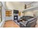 Cozy living room boasts a fireplace, built-in shelves, and a comfortable leather sectional at 1085 Highland Crest Ct, Mableton, GA 30126