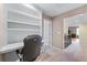 Upstairs office space with custom bookshelves, carpeted floor, and a neutral wall color at 1085 Highland Crest Ct, Mableton, GA 30126