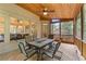 Relaxing screened-in porch with a dining table, fan, and wood ceiling at 1085 Highland Crest Ct, Mableton, GA 30126