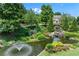 Scenic pond with a fountain and landscaping, creating a serene and picturesque community feature at 1085 Highland Crest Ct, Mableton, GA 30126