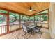 Screened-in porch with wood ceiling, ceiling fan, and outdoor seating area at 1085 Highland Crest Ct, Mableton, GA 30126