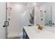 Bathroom featuring a glass shower, toilet, navy vanity, and gold fixtures for a stylish look at 1624 Gunnin Nw Trce, Atlanta, GA 30318