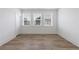 Bright bedroom features wood floors, three windows, and ample natural light for a comfortable space at 1624 Gunnin Nw Trce, Atlanta, GA 30318