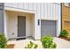 Welcoming front entrance featuring a gray front door, attached garage, and manicured landscaping at 1624 Gunnin Nw Trce, Atlanta, GA 30318