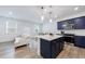 Beautiful kitchen with stainless steel appliances, quartz countertops, navy cabinets and island seating at 1624 Gunnin Nw Trce, Atlanta, GA 30318