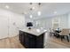 Beautiful kitchen featuring quartz countertops, an island with seating, stainless appliances and open living area at 1624 Gunnin Nw Trce, Atlanta, GA 30318
