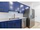 Modern kitchen featuring stainless steel appliances, white countertops, and stylish blue cabinets at 1624 Gunnin Nw Trce, Atlanta, GA 30318
