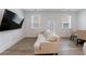 Living area showing a sofa, TV, and a dining area with backyard door at 1624 Gunnin Nw Trce, Atlanta, GA 30318